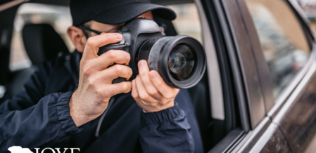 Image of someone taking photos out the window of their car with a camera with a zoom lens