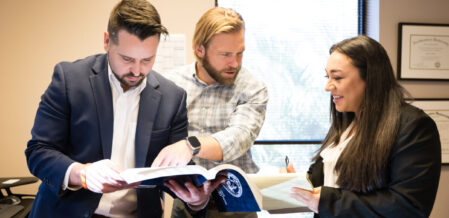 Three attorneys discussing a case