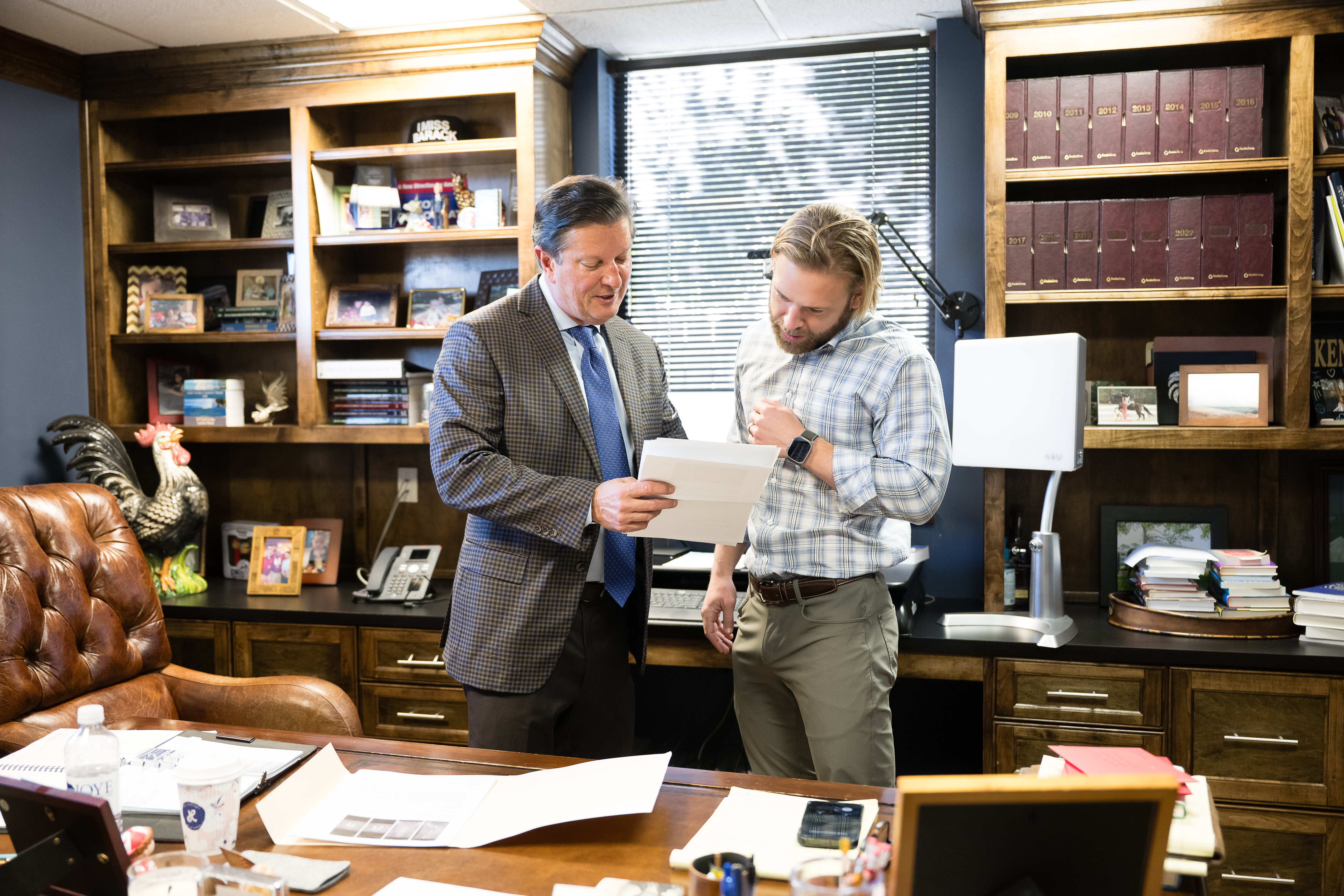 Managing Partner Ken Harrell and Attorney John Aylor discuss a car accident case in the North Charleston office on Rivers Avenue